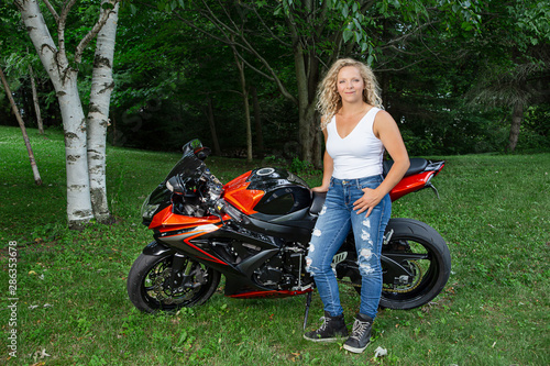 Blonde woman with motocycle