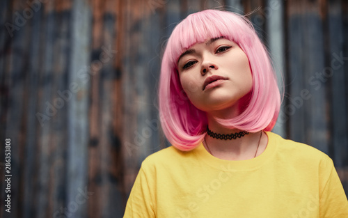 Valokuva Pensive Asian woman with pink hair