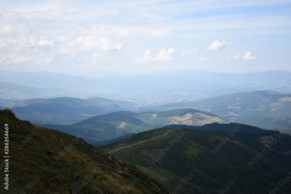 View while climbing Mount Hoverla. View of the mountain, forests and clouds. Ukrainian Carpathians.