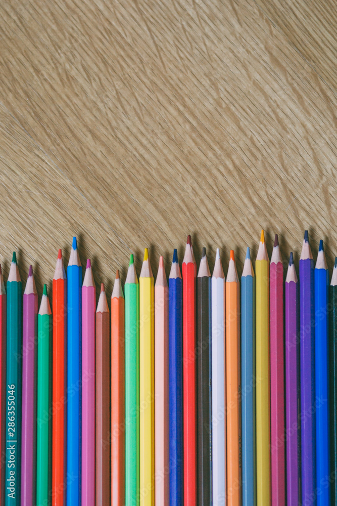 Color pencils on wooden background with copy space. Back to school and education concept. Color pencils on wooden background with copy space. Back to school and education concept.
