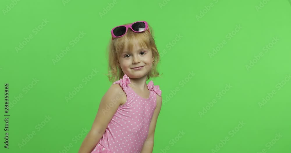 Child in pink swimsuit doing sports exercises, girl fitness training and dancing Child in pink swimsuit doing sports exercises, girl fitness training and dancing