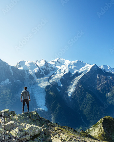 Man posing in front of Montblanc in the French Alps in Chamonix during a summer holiday trip. freedom and sport. Mountain and nature.
