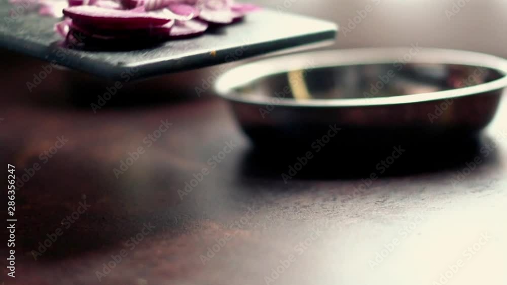 Closeup of male hands putting onion to the pot, slow motion Closeup of male hands putting onion to the pot, slow motion