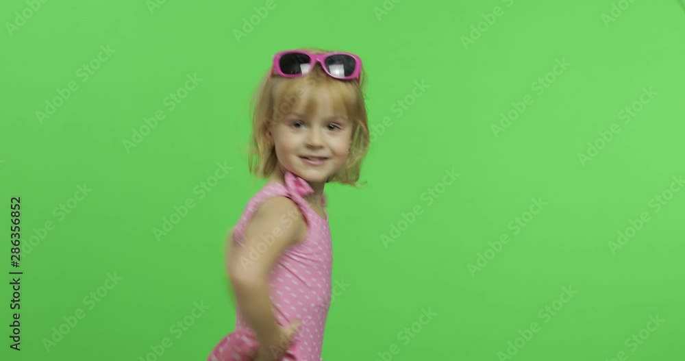 Child in pink swimsuit doing sports exercises, girl fitness training and dancing Child in pink swimsuit doing sports exercises, girl fitness training and dancing