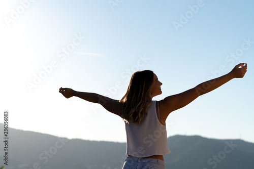 young beautiful caucasian woman with open arms outstretched