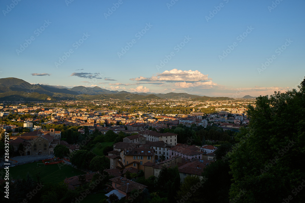 Bergamo with Alps mountains and blue cloudy sky