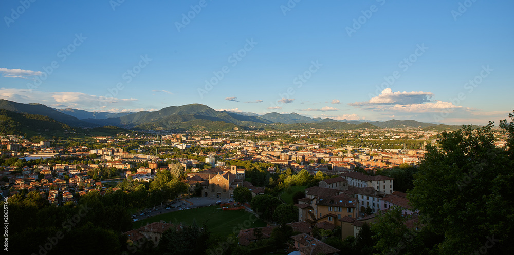 Obraz premium Bergamo with Alps mountains and blue cloudy sky