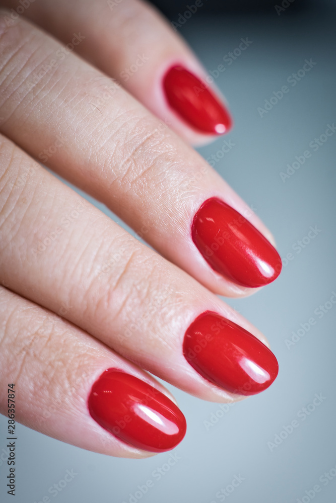 Female hand with a beautiful red manicure Female hand with a beautiful red manicure