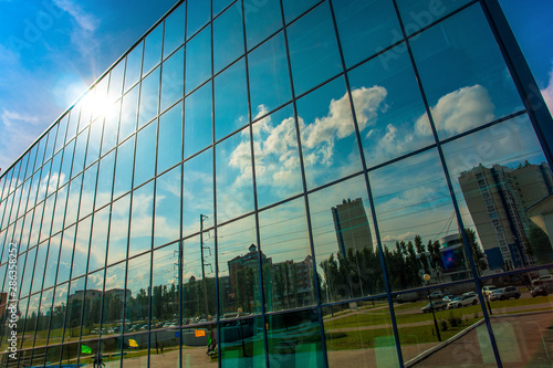 reflection of the blue sky in the Windows of the business center close-up