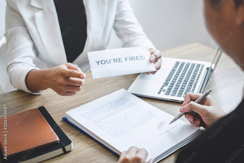 Stressed businessman receive fired letter from employer will be signing approve contract agreement, changing and resigning from work concept Stressed businessman receive fired letter from employer will be signing approve contract agreement, changing and resigning from work concept
