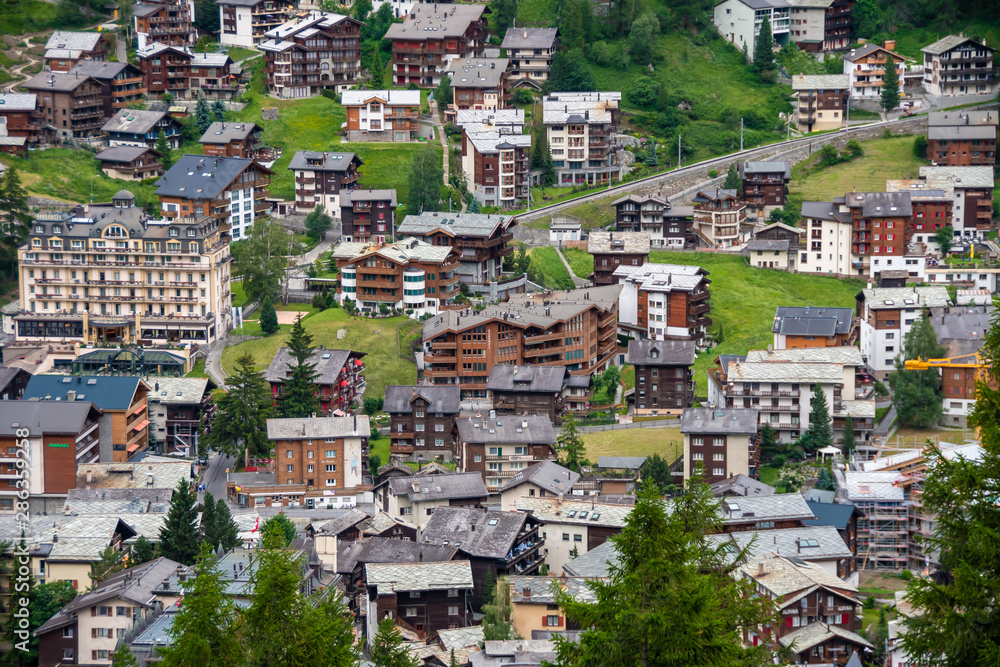 View of village Zermatt, hotels and traditional chalets. ZERMATT, SWITZERLAND - JULY 02, 2019