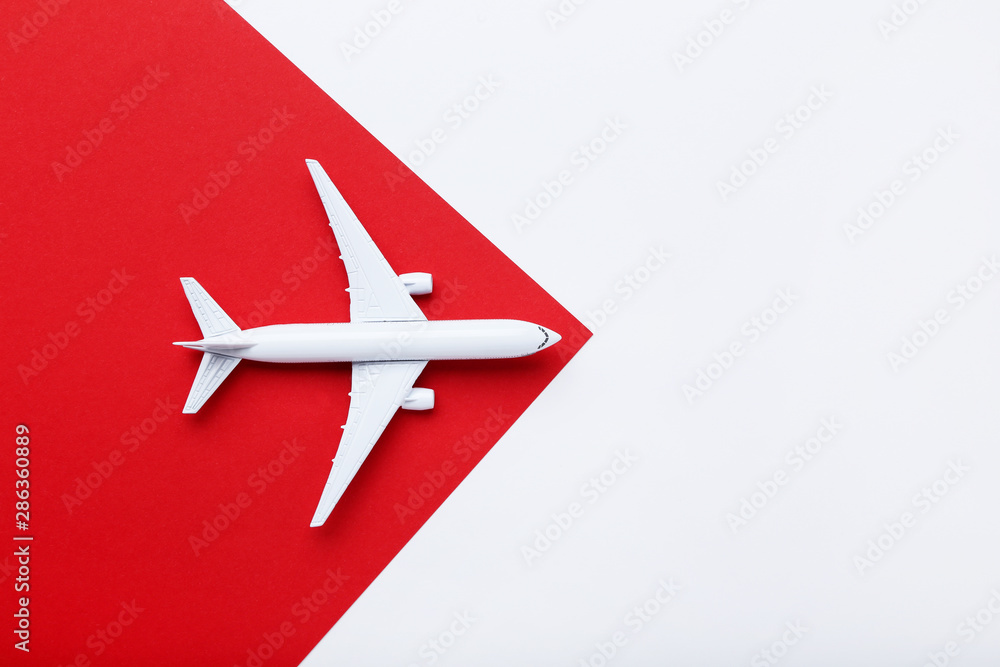 Fototapeta premium Airplane model on red paper background