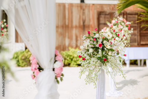 Romantic wedding ceremony on the beach. Wedding setting on the beach. Flowers wedding ceremony by the sea.Beach wedding interior decor.