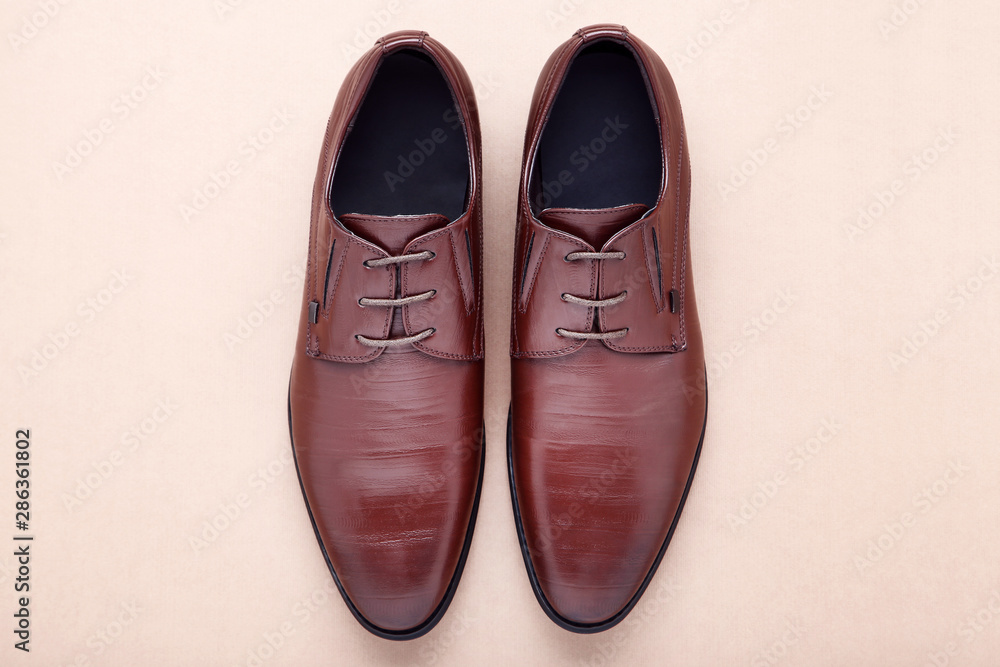 Male leather shoes on beige background Male leather shoes on beige background