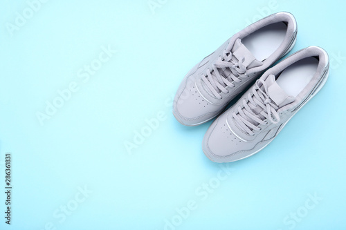Grey sport shoes on blue background