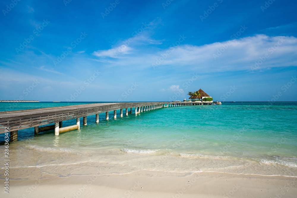 Wooden pier with blue sea and sky background