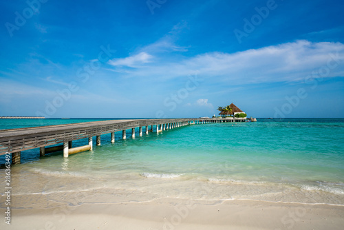 Wooden pier with blue sea and sky background