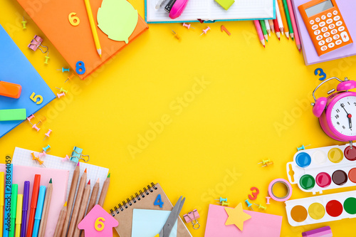 Different school supplies on yellow background