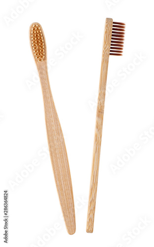 Two brown wooden toothbrushes on a white background. Bamboo toothbrush.