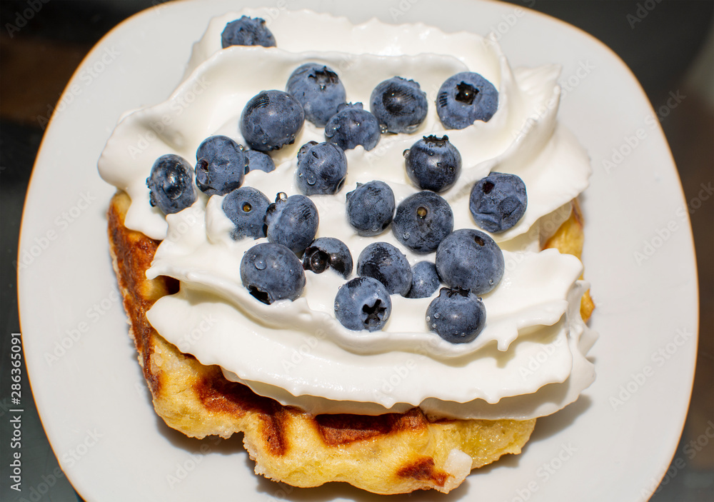 Liege Belgian Waffles with Pearl Sugar with cream and blueberry Liege Belgian Waffles with Pearl Sugar with cream and blueberry