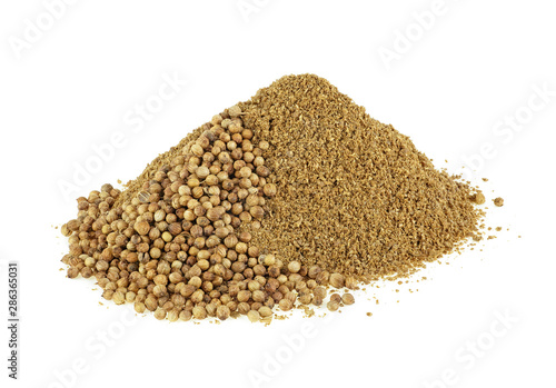 Pile of coriander powder with seeds isolated on a white background