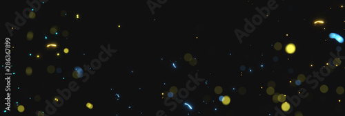 blurred yellow and blue sparks from neon lights in front of black backgound