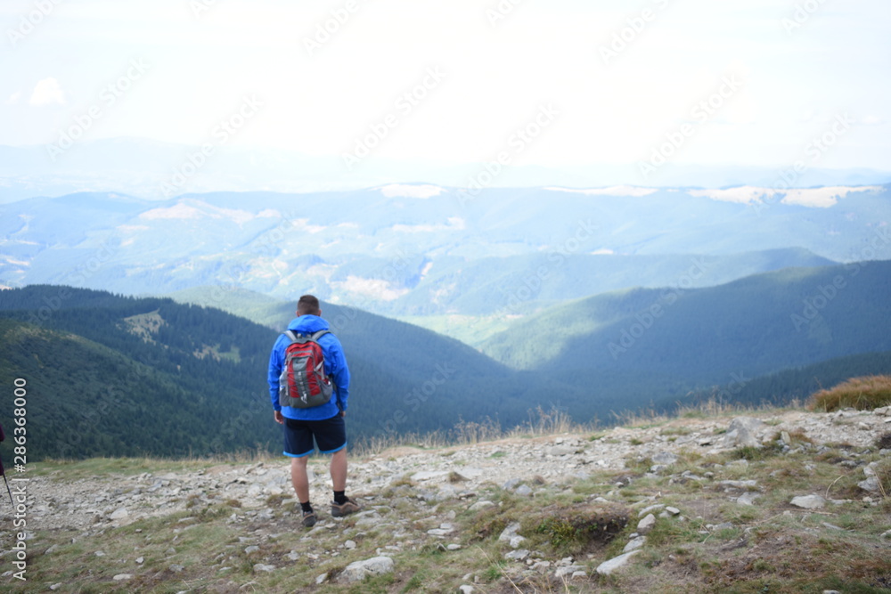 Tourist standing on Carpathian Mountains overlooking the Goverla view