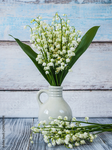 Slika na platnu Lily of the valey on the wooden backround
