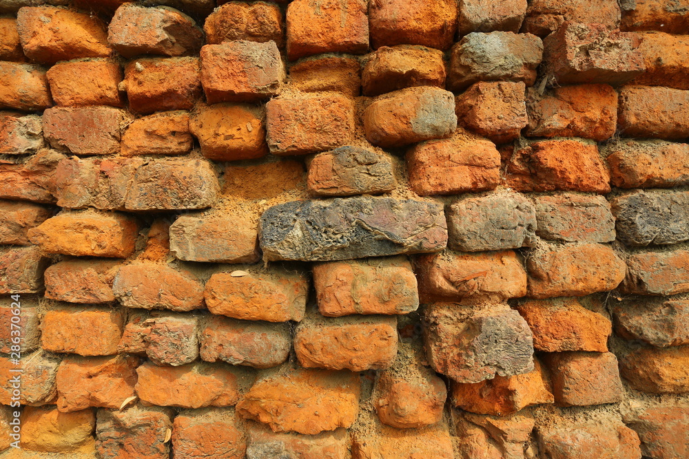 Old orange and red breakable brick arch wall with pattern. Old orange and red breakable brick arch wall with pattern.