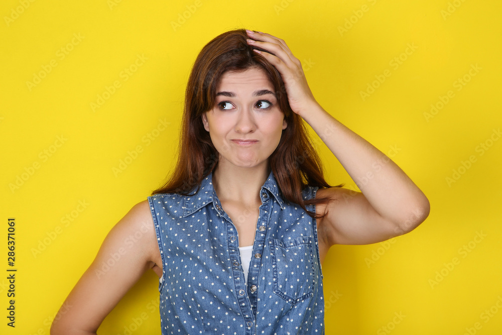 Young woman in stylish clothing on yellow background Young woman in stylish clothing on yellow background