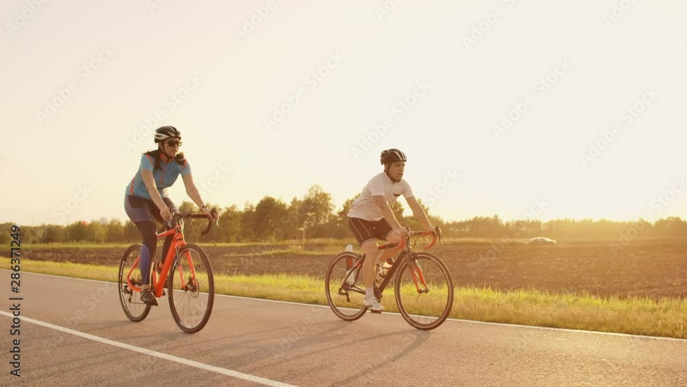 Tracking shot of a group of cyclists on country road. Fully released for commercial use Tracking shot of a group of cyclists on country road. Fully released for commercial use