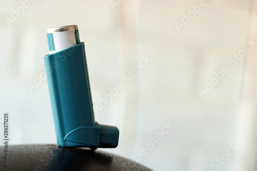 Medicine and health concept: Blue inhaler.