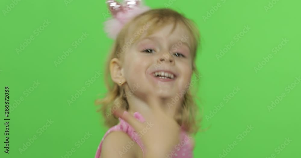 Positive girl in pink swimsuit emotionally gestures with her hands. Chroma Key