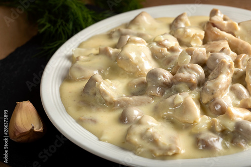 Chicken meat with mushrooms and cream photo