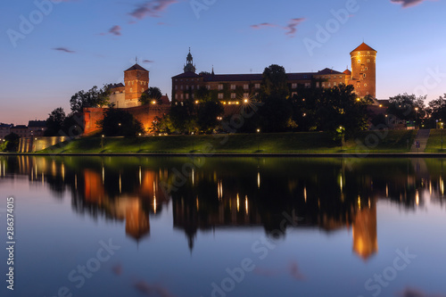 Wawel castle at sunrise reflected in the Vistula river