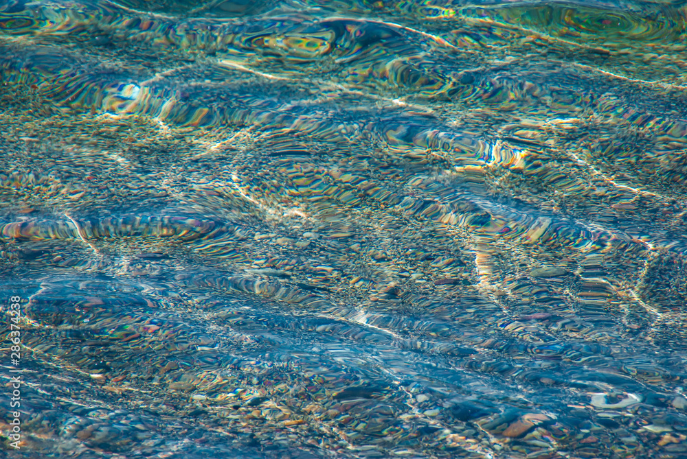 Background of stones in crystal blue water Background of stones in crystal blue water