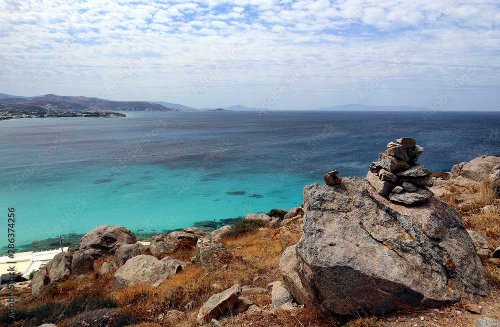 Turquoise Aegen Sea at Naxos and a cairn rock pile, Looking over to Paros, Greek Islands