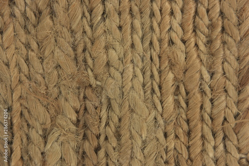 light brown natural woven beach seagrass fibers close up texture with flat neutral lighting