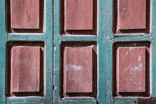 Wooden window background with pink rectangles and emerald blue slats