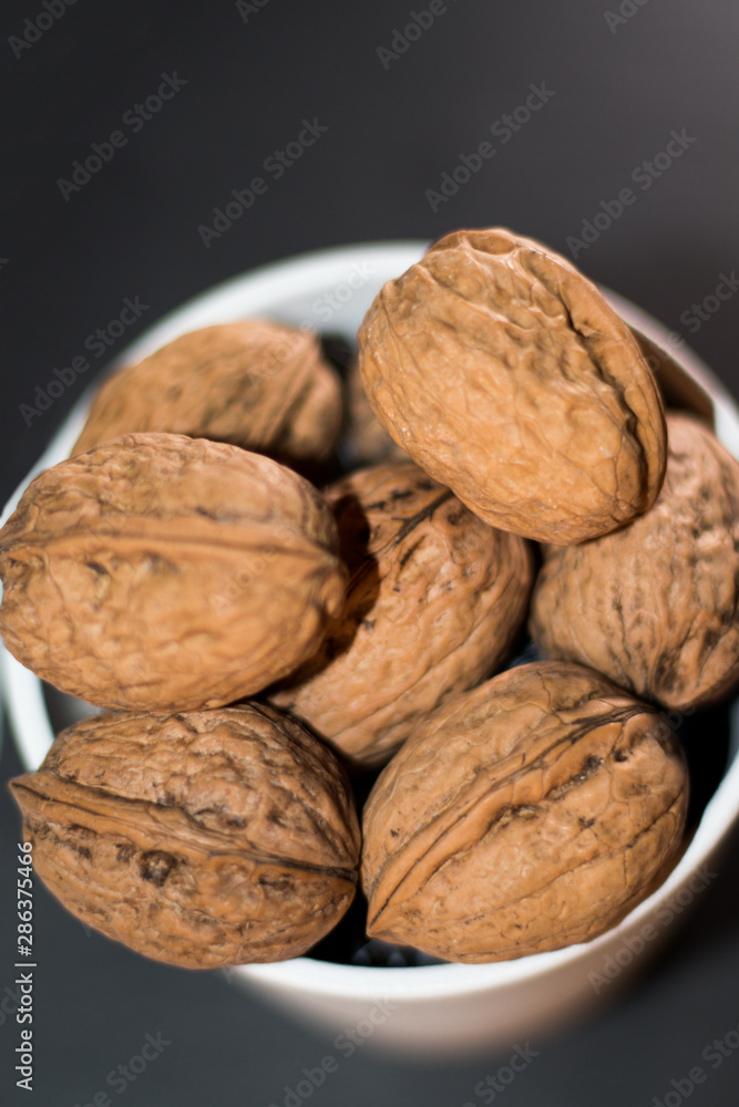 white bucket full of nuts on black background white bucket full of nuts on black background