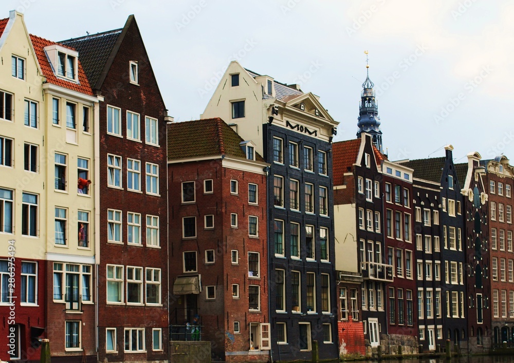 Romantic Amsterdam Couple Talking Through Windows In Dancing Houses On River Canal