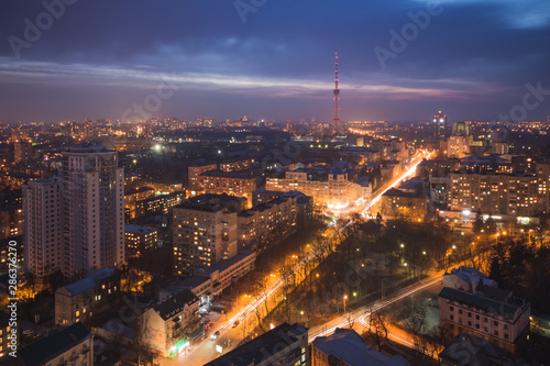 City quarter from a height. Streets and houses at night. Roofs Skyline at sunset..