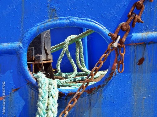 detail of the deck of a fishing boat docked at the port with ropes