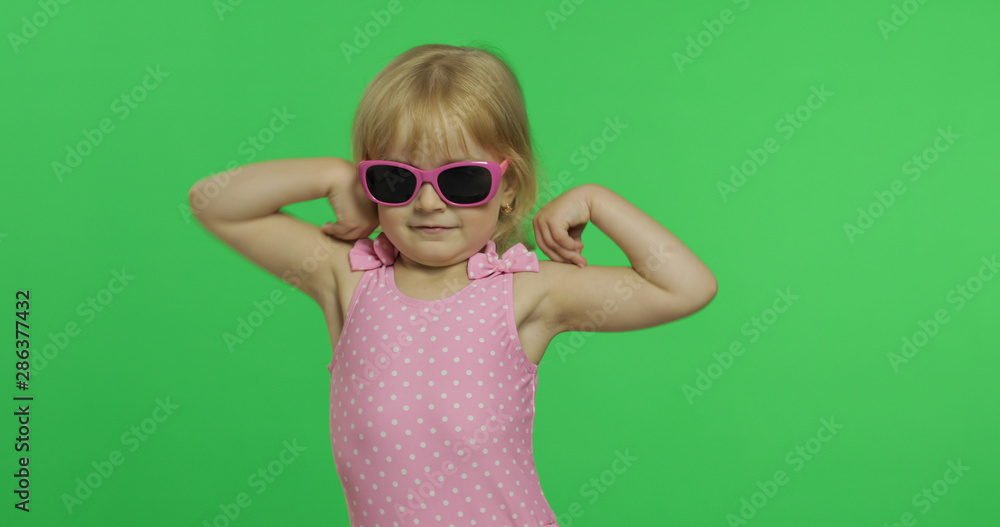 Child in pink swimsuit doing sports exercises, girl fitness training, dancing Child in pink swimsuit doing sports exercises, girl fitness training, dancing