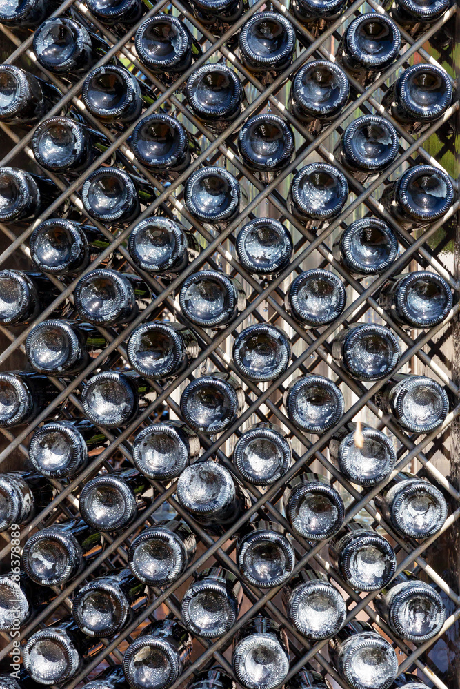 Washing bottles of champagne at the factory. Classical manufacturing technology.
