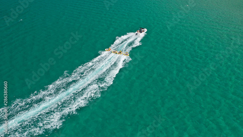 Aerial drone photo of extreme powerboat donut water-sports cruising in high speed in tropical turquoise bay © aerial-drone
