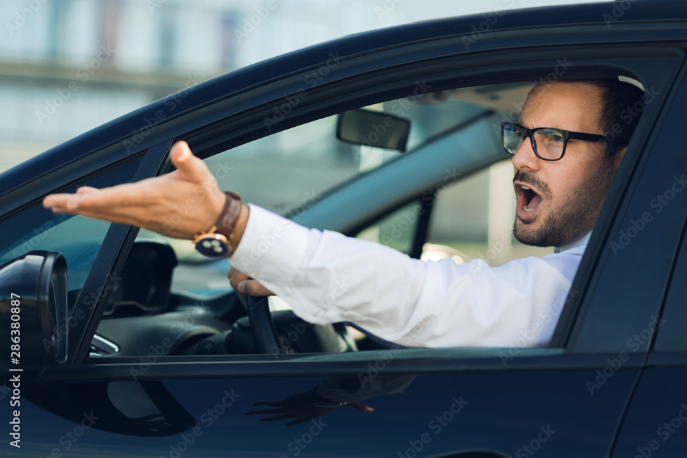 Angry businessman yelling out car window