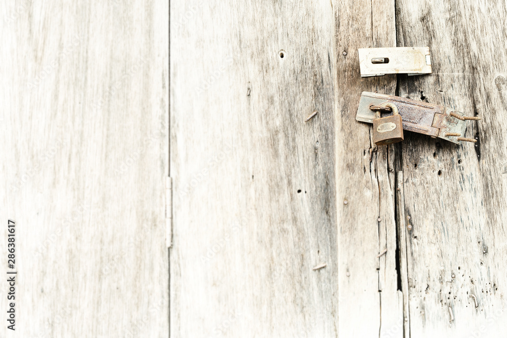 Old and rusty padlock on wooden door. Old and rusty padlock on wooden door.