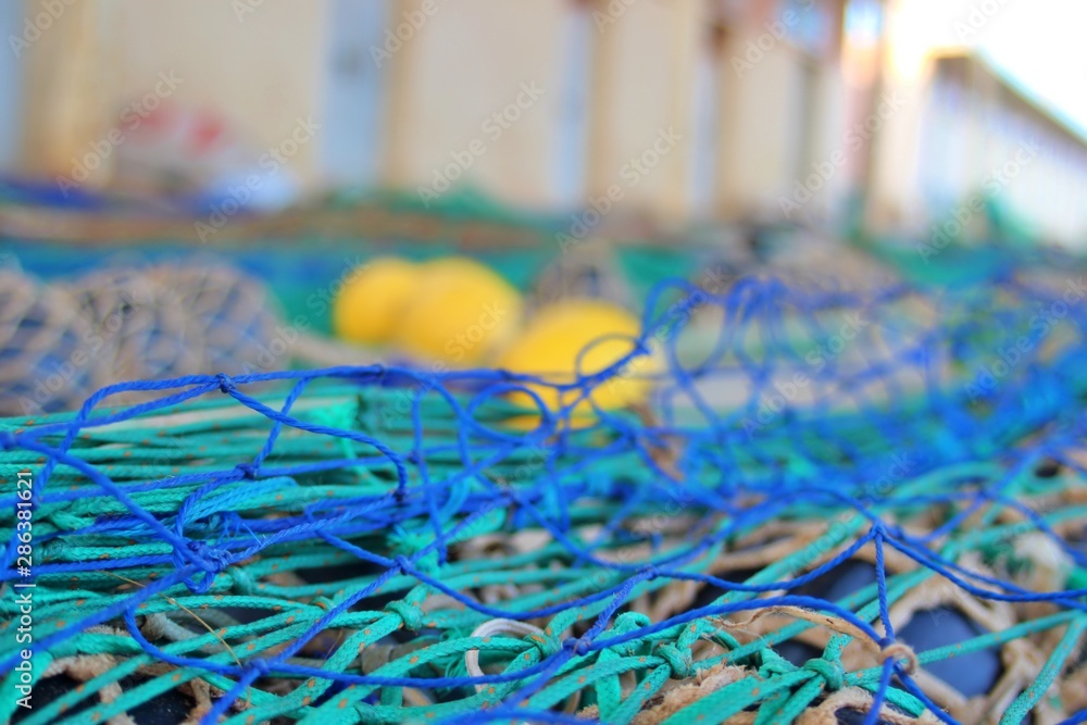 Fototapeta premium close-up view of extended fishing nets on the harbor floor