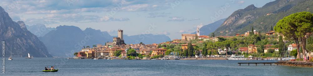 Malcesine - The panorama of promenade over the Lago di Garda lake with the town and castle in the background.